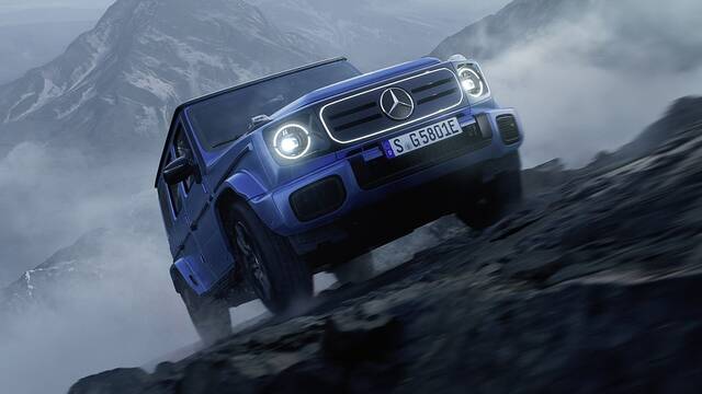 2025 Mercedes-Benz Electric G-Class driving up a mountain