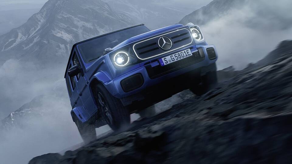 2025 Mercedes-Benz Electric G-Class driving up a mountain