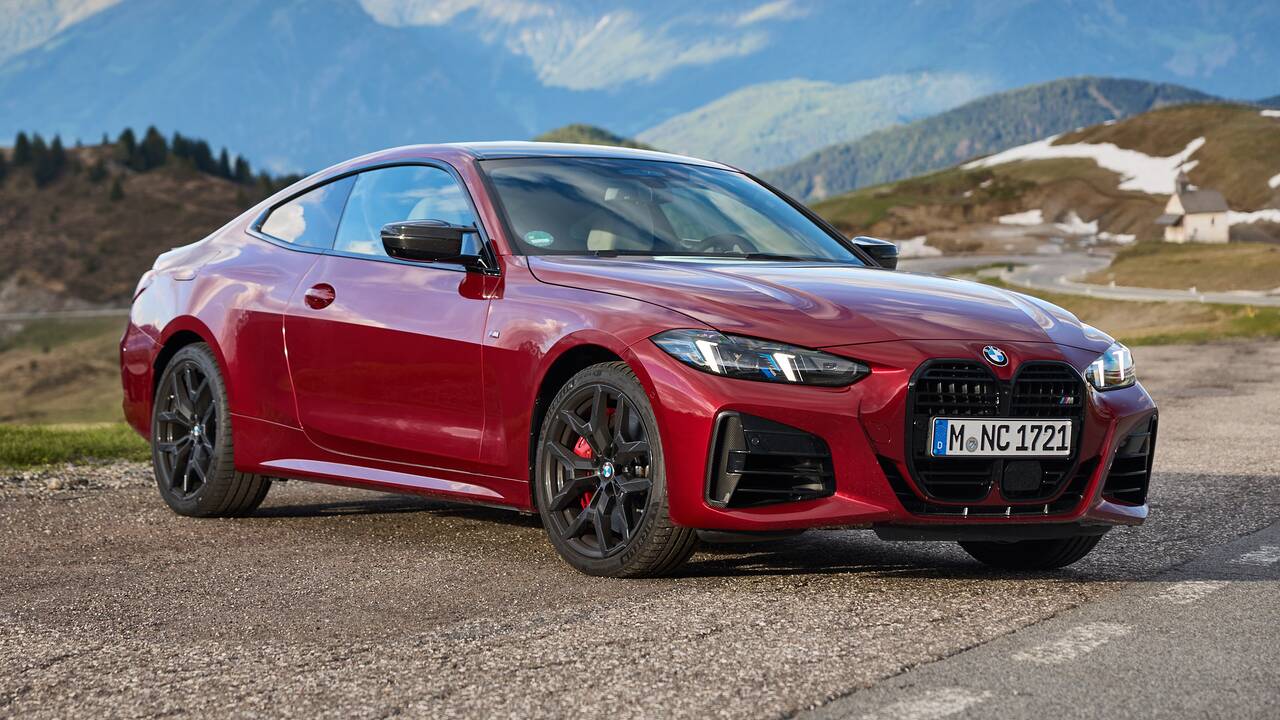 2025 BMW M440i Coupe parked front view with mountains in the background