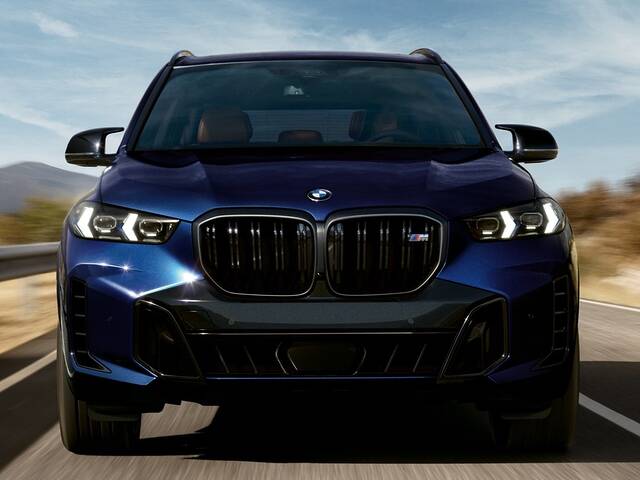 2025 BMW X5 M60i xDrive driving front view closeup