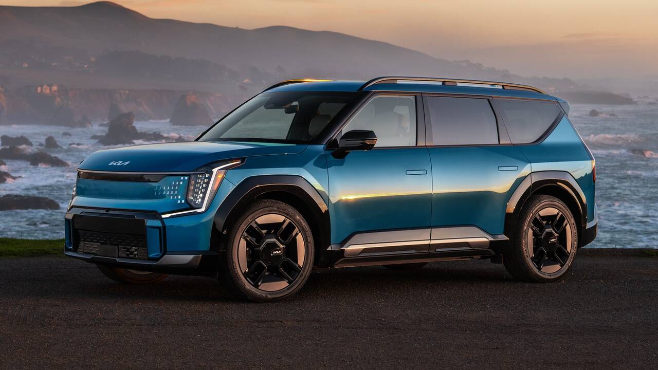 2025 Kia EV9 parked beside the ocean at sunset