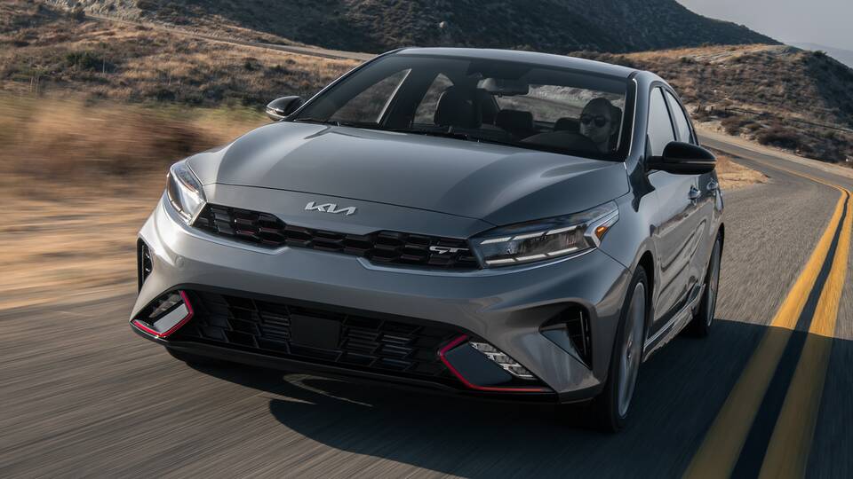 2024 Kia Forte GT driving on a scenic California backroad