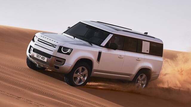2024 Land Rover Defender driving on sand dunes