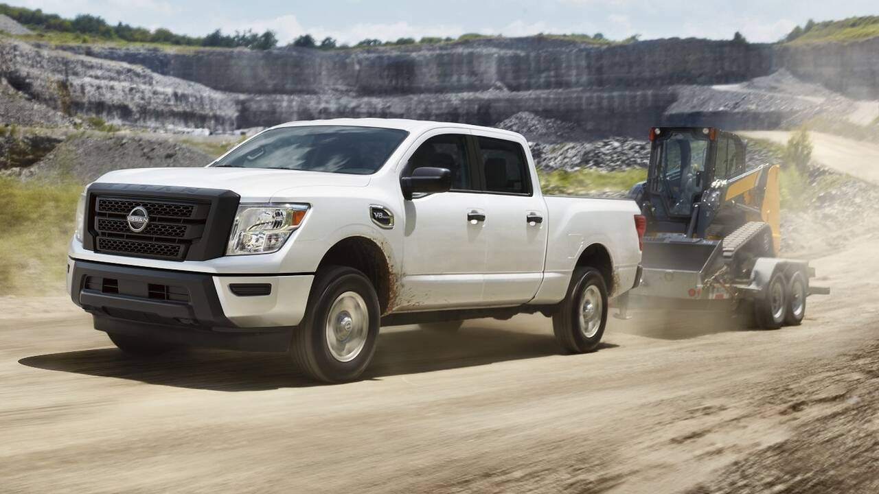 2024 Nissan Titan XD towing a bulldozer front view