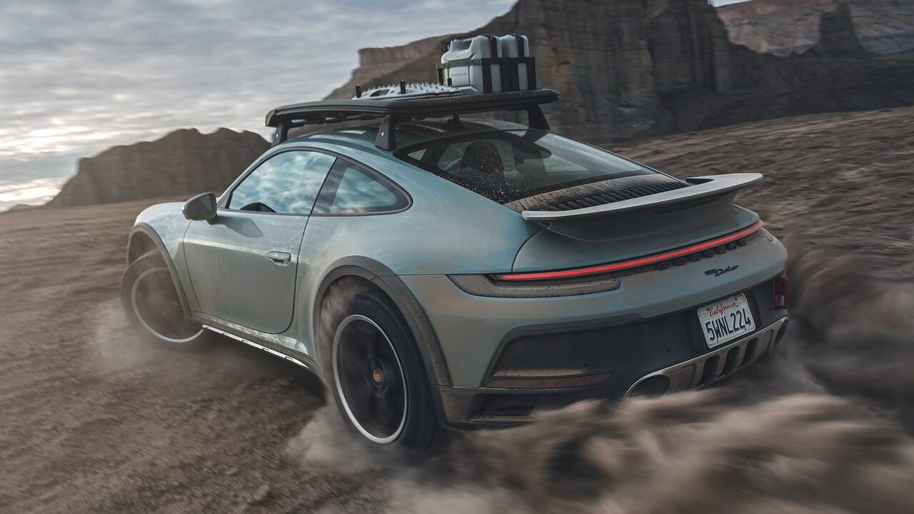2024 Porsche 911 Dakar driving off-road rear view