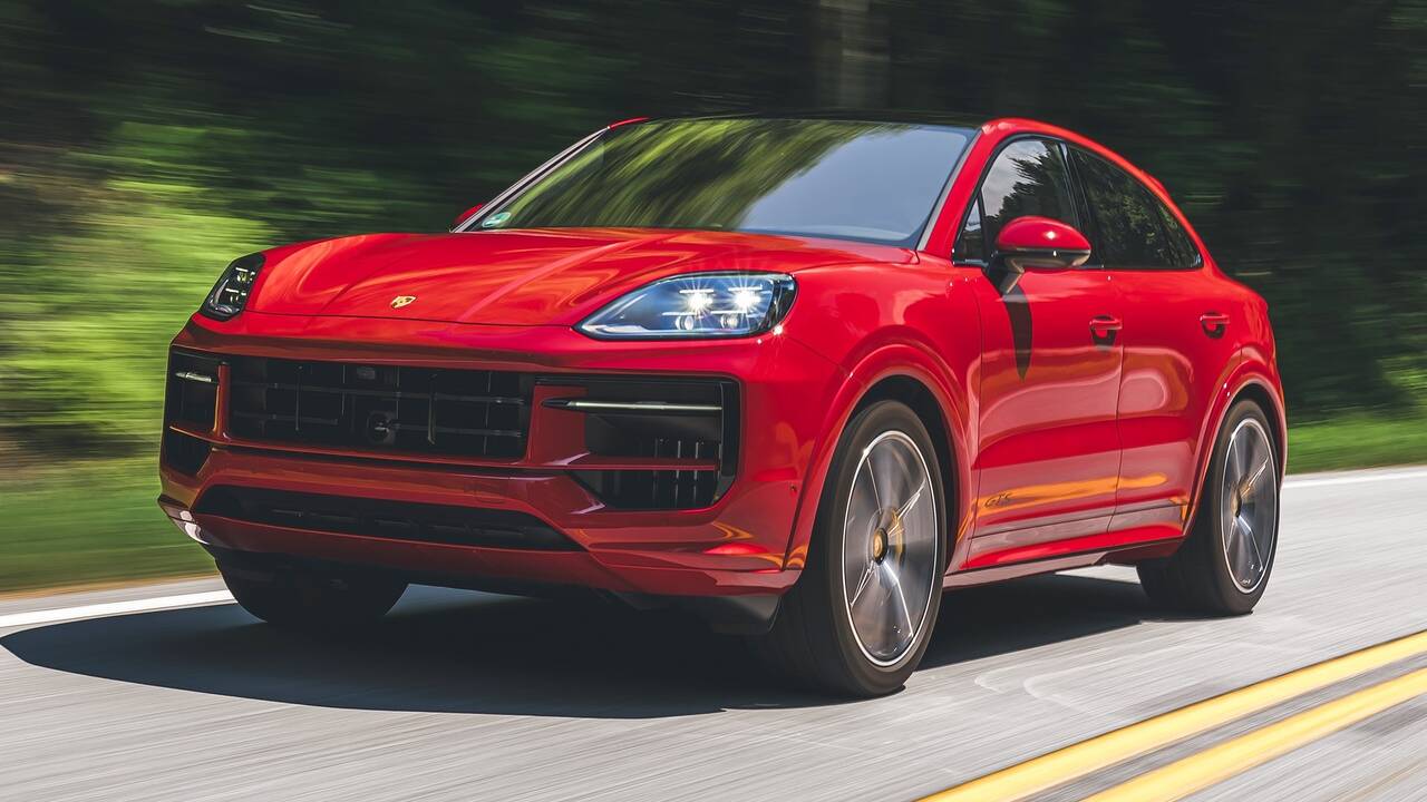 2025 Porsche Cayenne GTS Coupe driving front view - Carmine Red