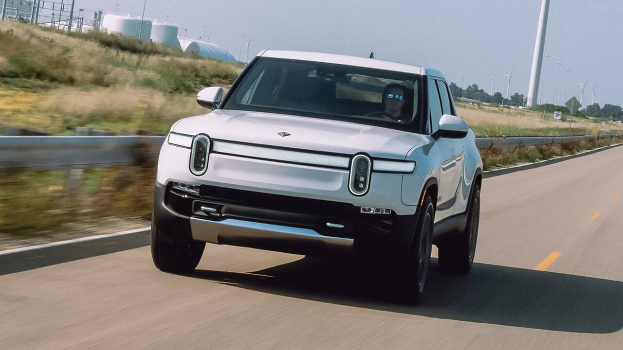 2024 Rivian R1T driving front view (white)