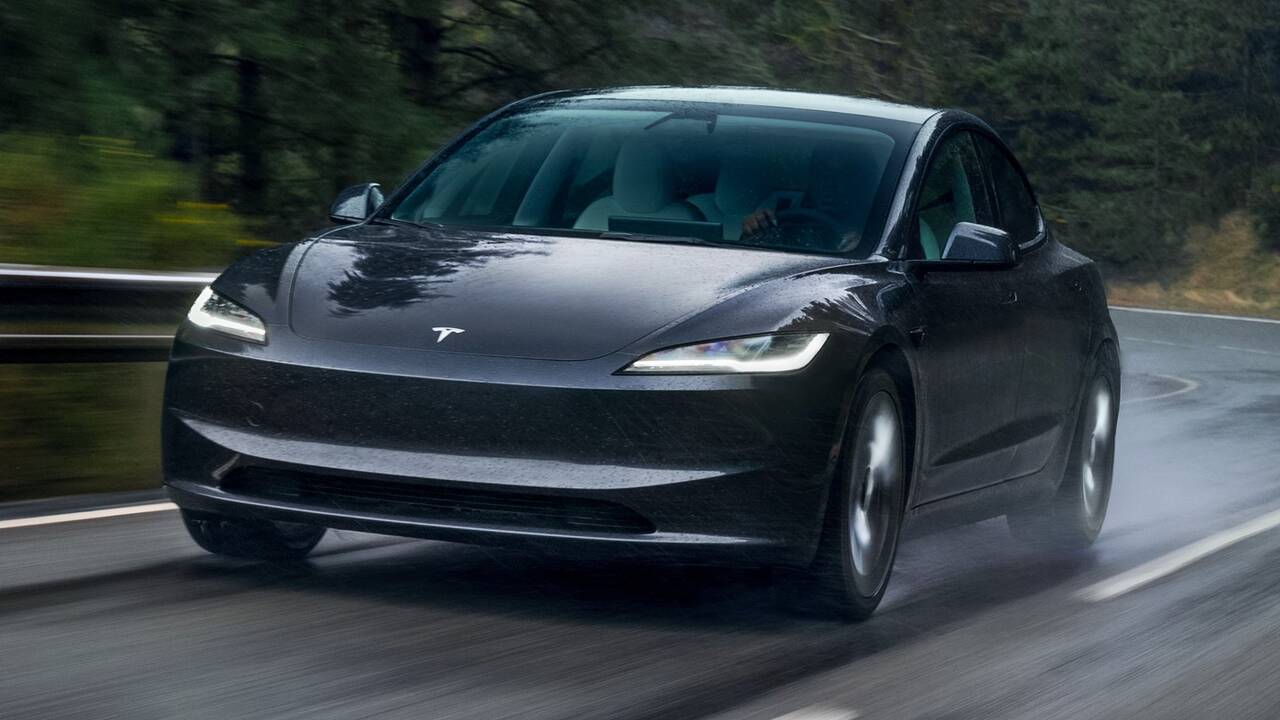 2025 Tesla Model 3 driving front view in the rain