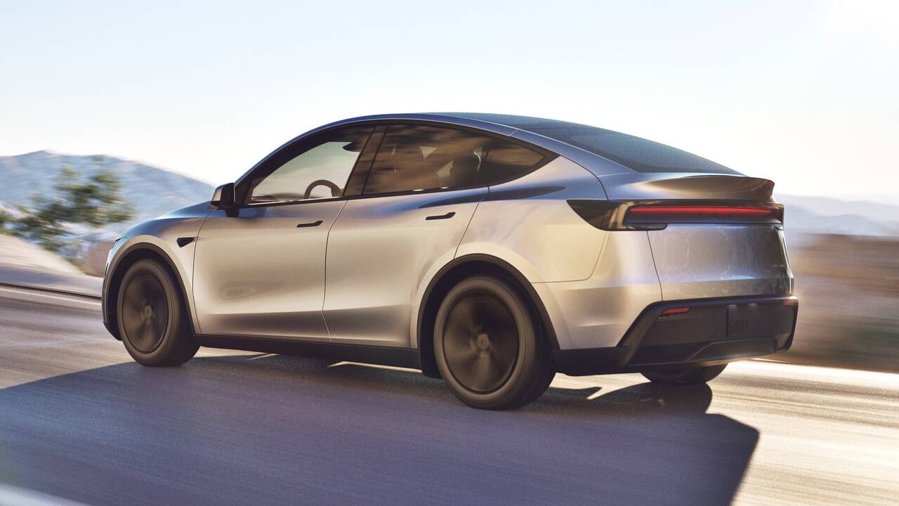 2025 Tesla Model Y driving rear view